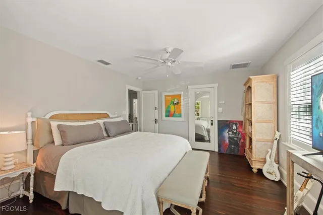 a spacious bedroom with two beds and a chandelier