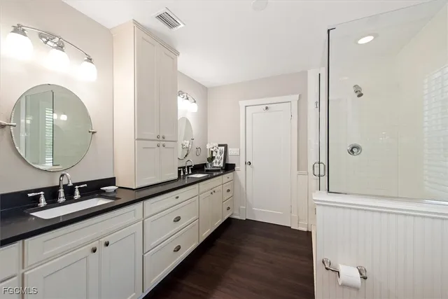 a bathroom with a double vanity sink and a mirror