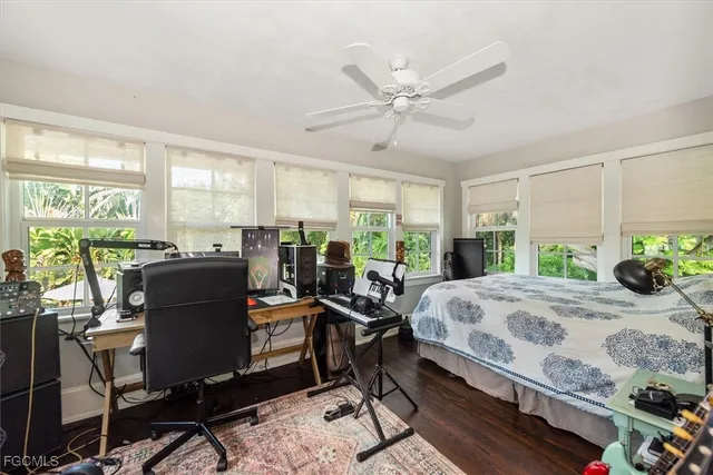 a bedroom with a bed a large window and chair