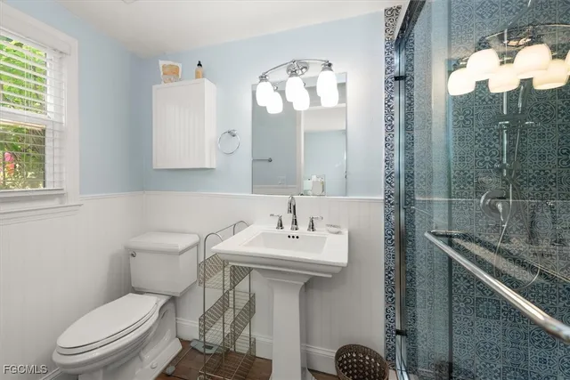 a bathroom with a sink toilet and shower