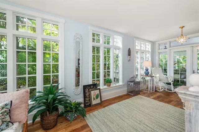 a living room with furniture and large windows