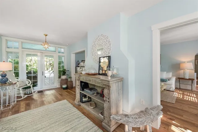 a view of a livingroom with furniture hardwood floor and a large window