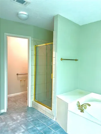 a bathroom with a bathtub and a shower
