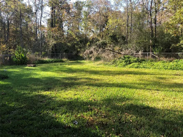 a yard with swimming pool and green space