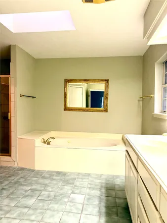 a bathroom with a bathtub and a sink