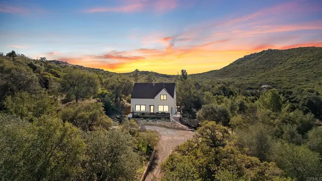a roof deck with couches and wooden fence