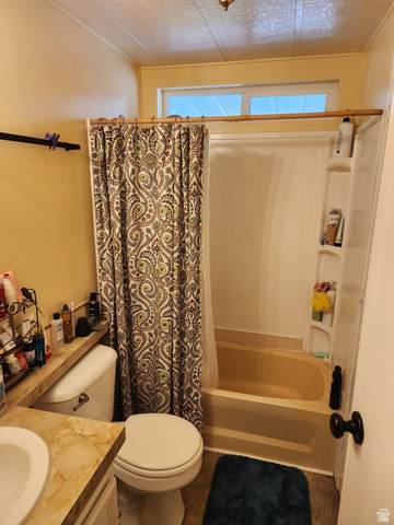 11362 Crescent Park Way, Unit 8 Sandy, UT 84070 - Photo 6 of 20 Bathroom with vanity, shower / bathtub combination with curtain, a textured ceiling, and plenty of natural light