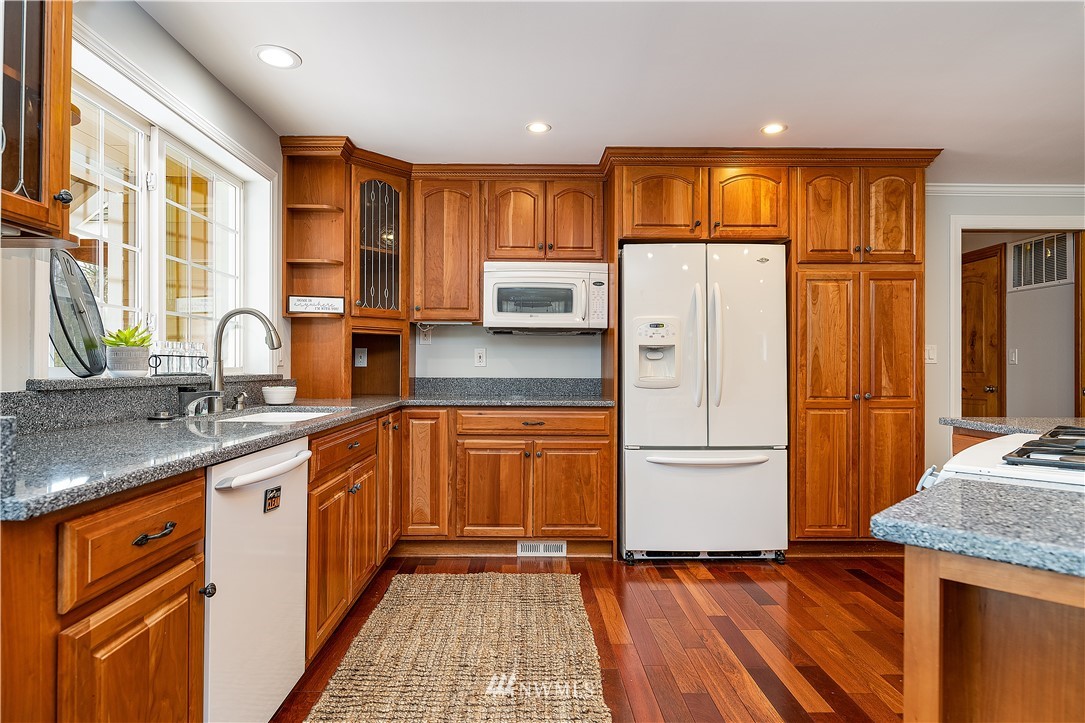 17325 3rd Avenue Southeast Bothell, WA 98012 - Photo 11 of 40 a kitchen with granite countertop a refrigerator stove top oven and sink