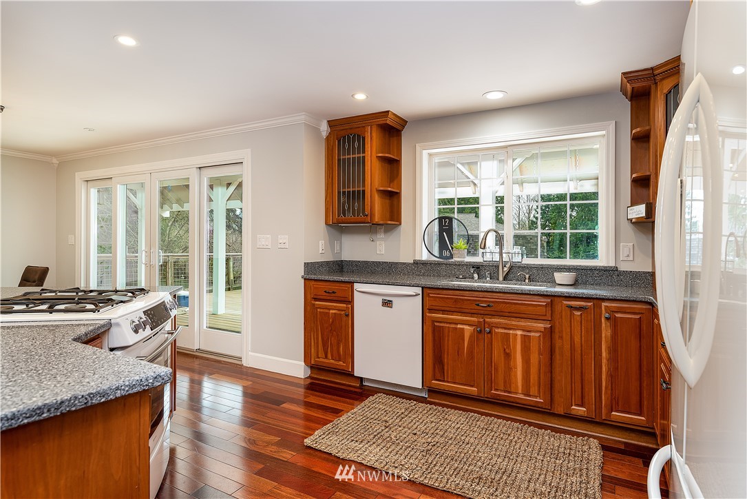 17325 3rd Avenue Southeast Bothell, WA 98012 - Photo 12 of 40 a kitchen with stainless steel appliances granite countertop wooden floors and sink
