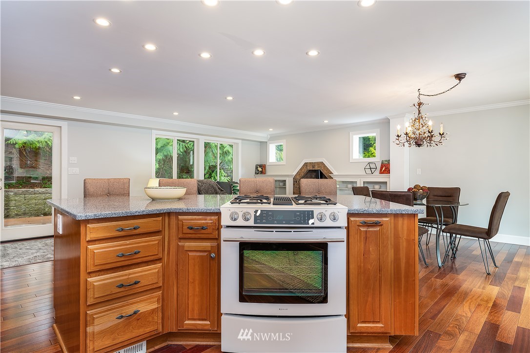 17325 3rd Avenue Southeast Bothell, WA 98012 - Photo 13 of 40 a kitchen with kitchen island granite countertop wooden cabinets and stainless steel appliances