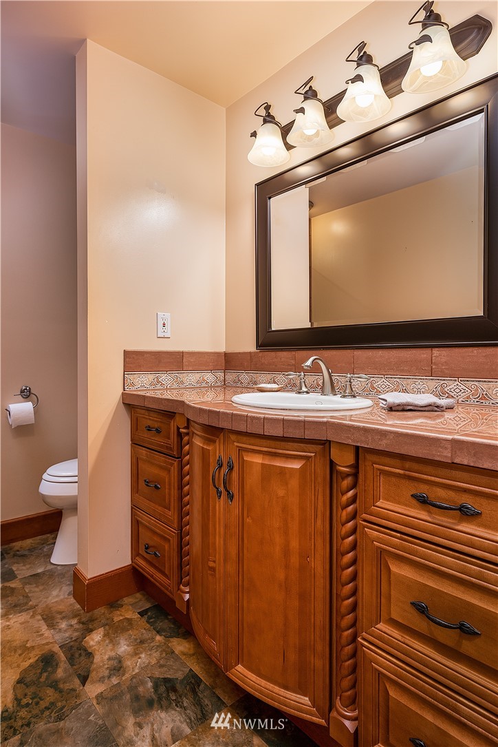 17325 3rd Avenue Southeast Bothell, WA 98012 - Photo 22 of 40 a bathroom with a sink a toilet and mirror