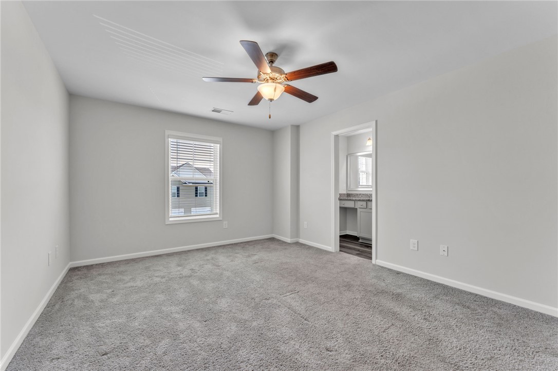 208 Samuel Street Pendleton, SC 29670 - Photo 12 of 32 A quiet bedroom with a ceiling fan offers peaceful repose and easy access to an adjoining bath.