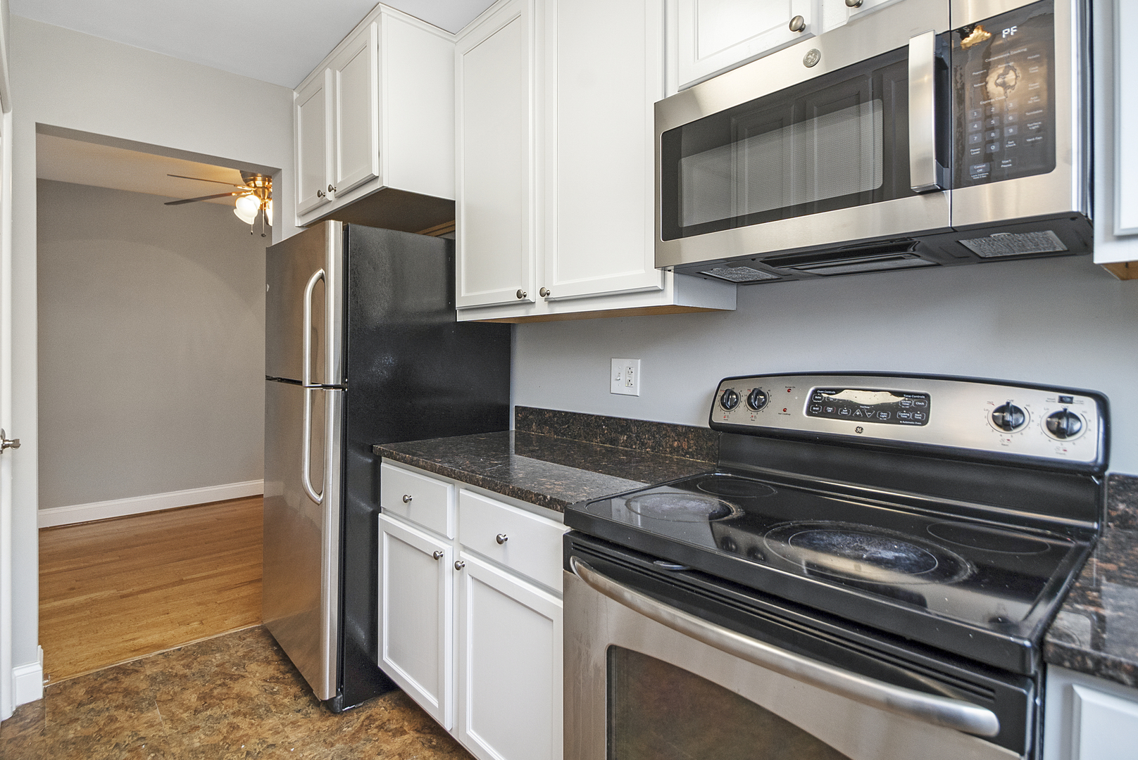 1951 Euclid Avenue, Unit 202 Berwyn, IL 60402 - Photo 6 of 16 a kitchen with stainless steel appliances granite countertop a refrigerator and a stove top oven