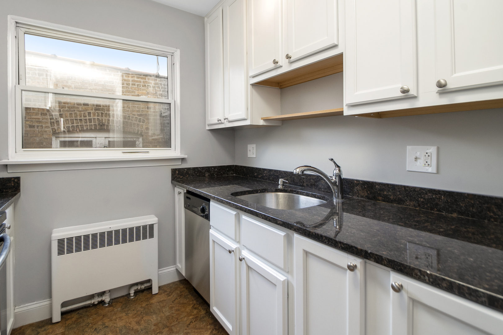 1951 Euclid Avenue, Unit 202 Berwyn, IL 60402 - Photo 7 of 16 a kitchen with stainless steel appliances granite countertop white cabinets and a window