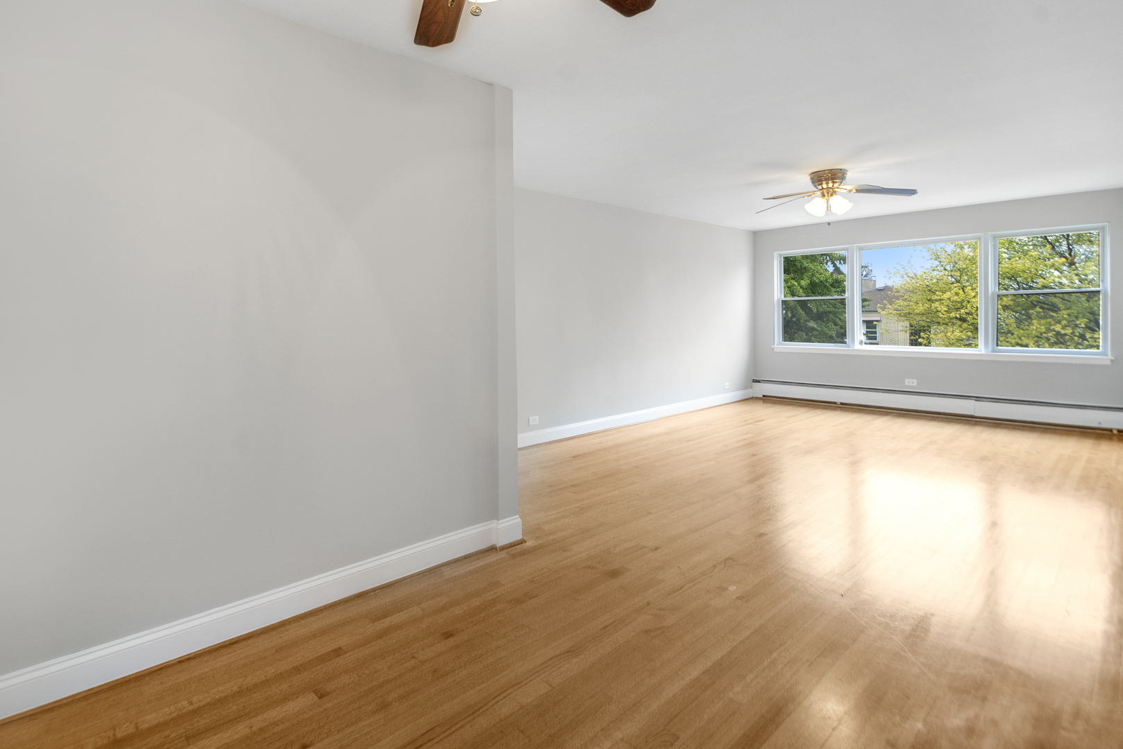 1951 Euclid Avenue, Unit 202 Berwyn, IL 60402 - Photo 9 of 16 an empty room with wooden floor and windows