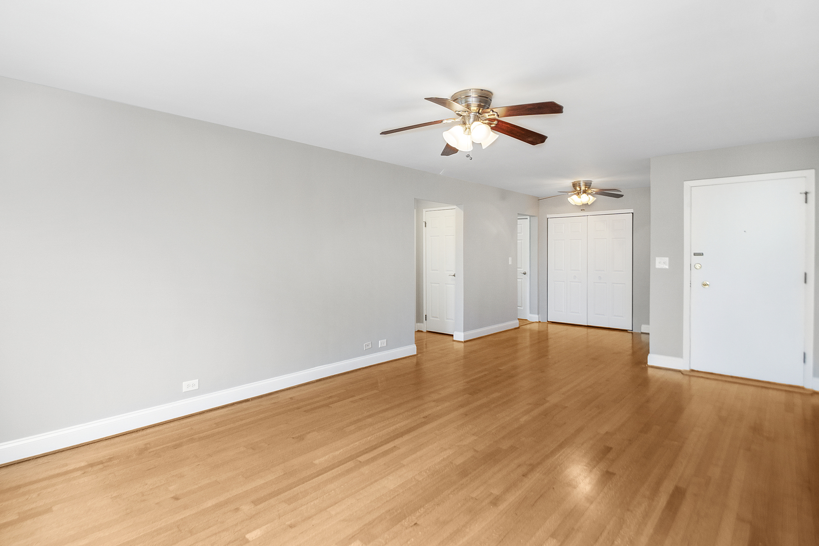 1951 Euclid Avenue, Unit 202 Berwyn, IL 60402 - Photo 10 of 16 a view of an empty room with wooden floor and a ceiling fan