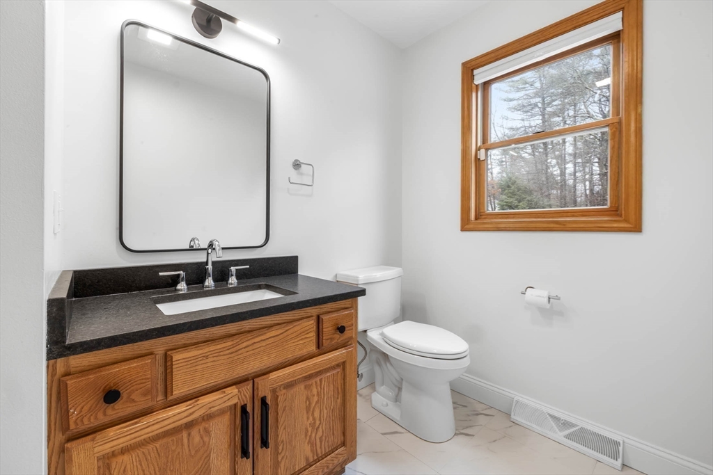 10 Alden Street Ludlow, MA 01056 - Photo 15 of 41 a bathroom with a granite countertop toilet sink and mirror