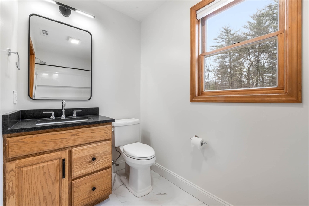 10 Alden Street Ludlow, MA 01056 - Photo 23 of 41 a bathroom with a toilet a sink a vanity and mirror