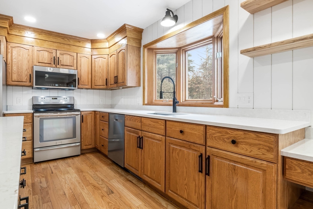 10 Alden Street Ludlow, MA 01056 - Photo 6 of 41 a kitchen with stainless steel appliances white cabinets and a sink