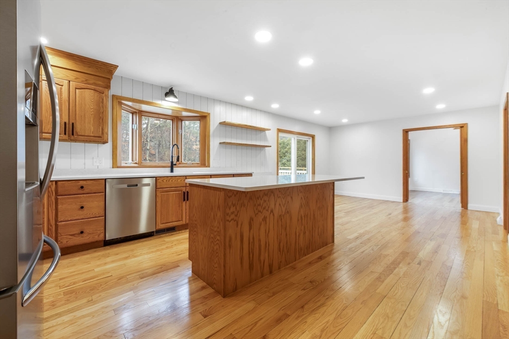 10 Alden Street Ludlow, MA 01056 - Photo 9 of 41 a kitchen with stainless steel appliances granite countertop a sink cabinets and wooden floor