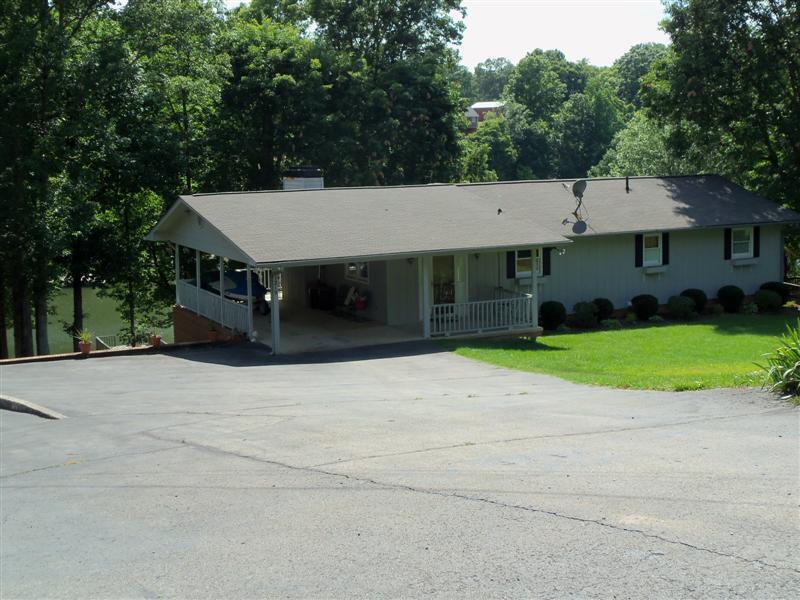 1219 Loggers Road Goodview, VA 24095 - Photo 19 of 21 a front view of a house with a yard and garage