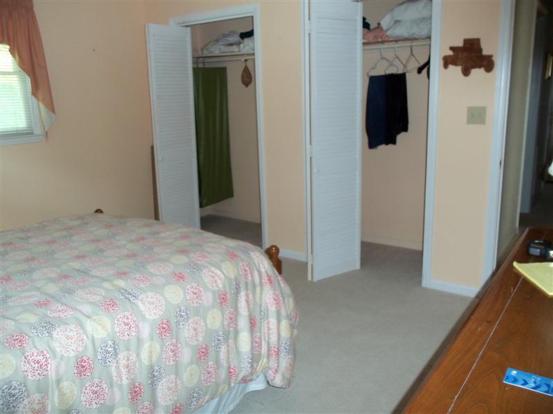 1219 Loggers Road Goodview, VA 24095 - Photo 5 of 21 a bedroom with a bed and a flat screen tv