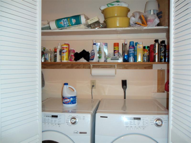 1219 Loggers Road Goodview, VA 24095 - Photo 9 of 21 a utility room with lots of clutter and cabinets