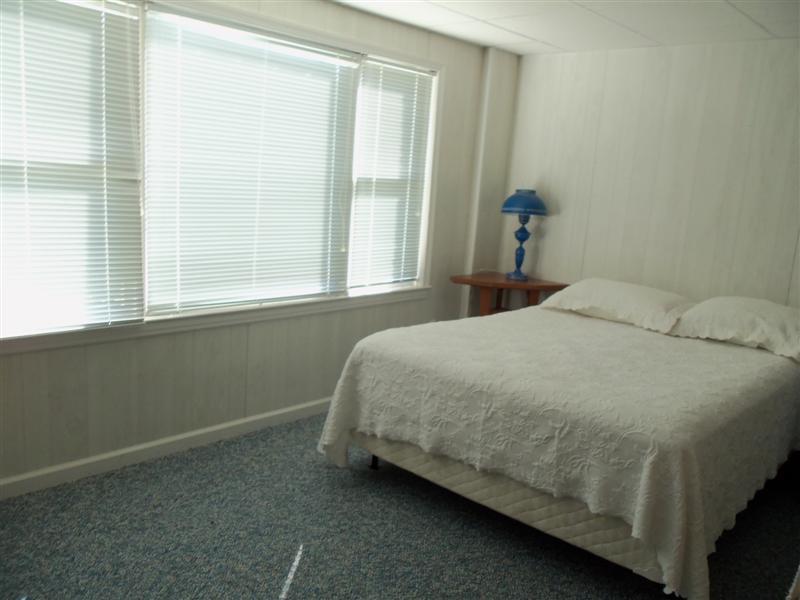 1219 Loggers Road Goodview, VA 24095 - Photo 10 of 21 a bed sitting in a bedroom next to a window