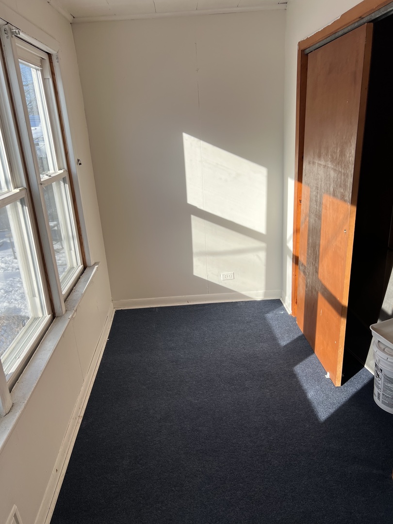 3741 West Irving Park Road, Unit 1 Chicago, IL 60618 - Photo 8 of 8 a view of an empty room with wooden floor and a window