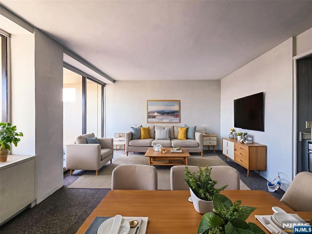 1 Horizon Road, Unit 811 Fort Lee, NJ 07024 - Photo 1 of 17 a living room with furniture and a flat screen tv