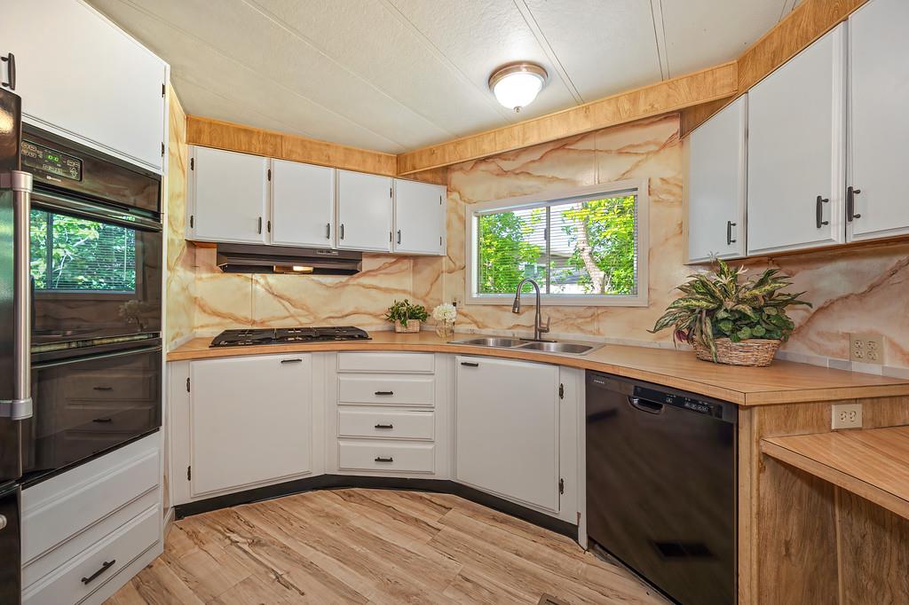 4800 Auburn Folsom Road, Unit 9 Loomis, CA 95650 - Photo 12 of 43 a kitchen with granite countertop white cabinets and white appliances