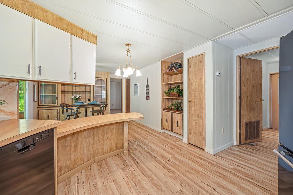 4800 Auburn Folsom Road, Unit 9 Loomis, CA 95650 - Photo 14 of 43 a kitchen with stainless steel appliances kitchen island granite countertop a refrigerator a stove and a wooden floors