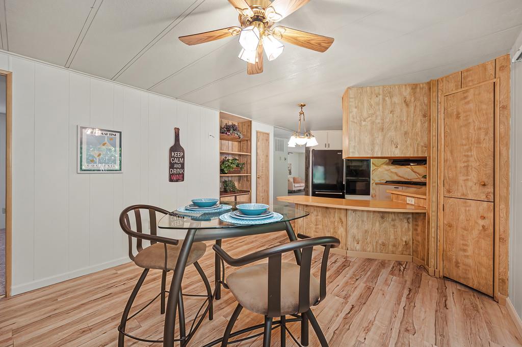 4800 Auburn Folsom Road, Unit 9 Loomis, CA 95650 - Photo 18 of 43 a view of a dining room with furniture and wooden floor