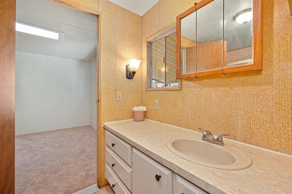 4800 Auburn Folsom Road, Unit 9 Loomis, CA 95650 - Photo 22 of 43 a bathroom with a sink and a mirror