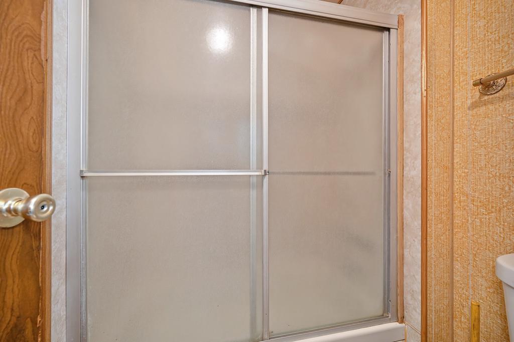 4800 Auburn Folsom Road, Unit 9 Loomis, CA 95650 - Photo 23 of 43 a bathroom with a glass shower door