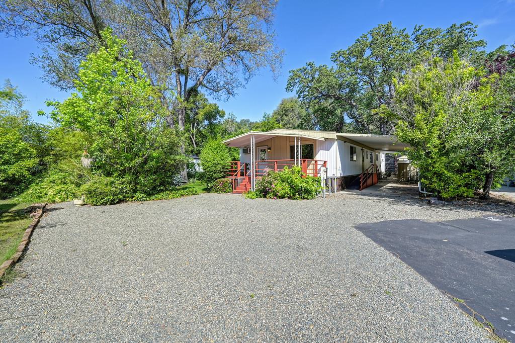 4800 Auburn Folsom Road, Unit 9 Loomis, CA 95650 - Photo 3 of 43 a front view of a house with a yard and potted plants