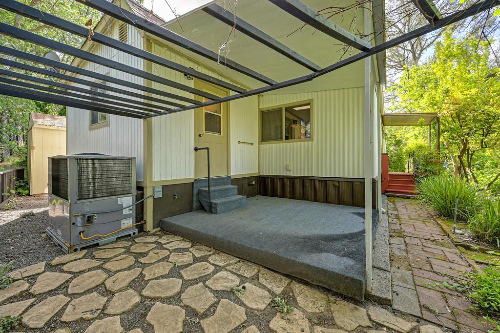 4800 Auburn Folsom Road, Unit 9 Loomis, CA 95650 - Photo 38 of 43 a view of a porch with a table and chairs and couches with wooden fence