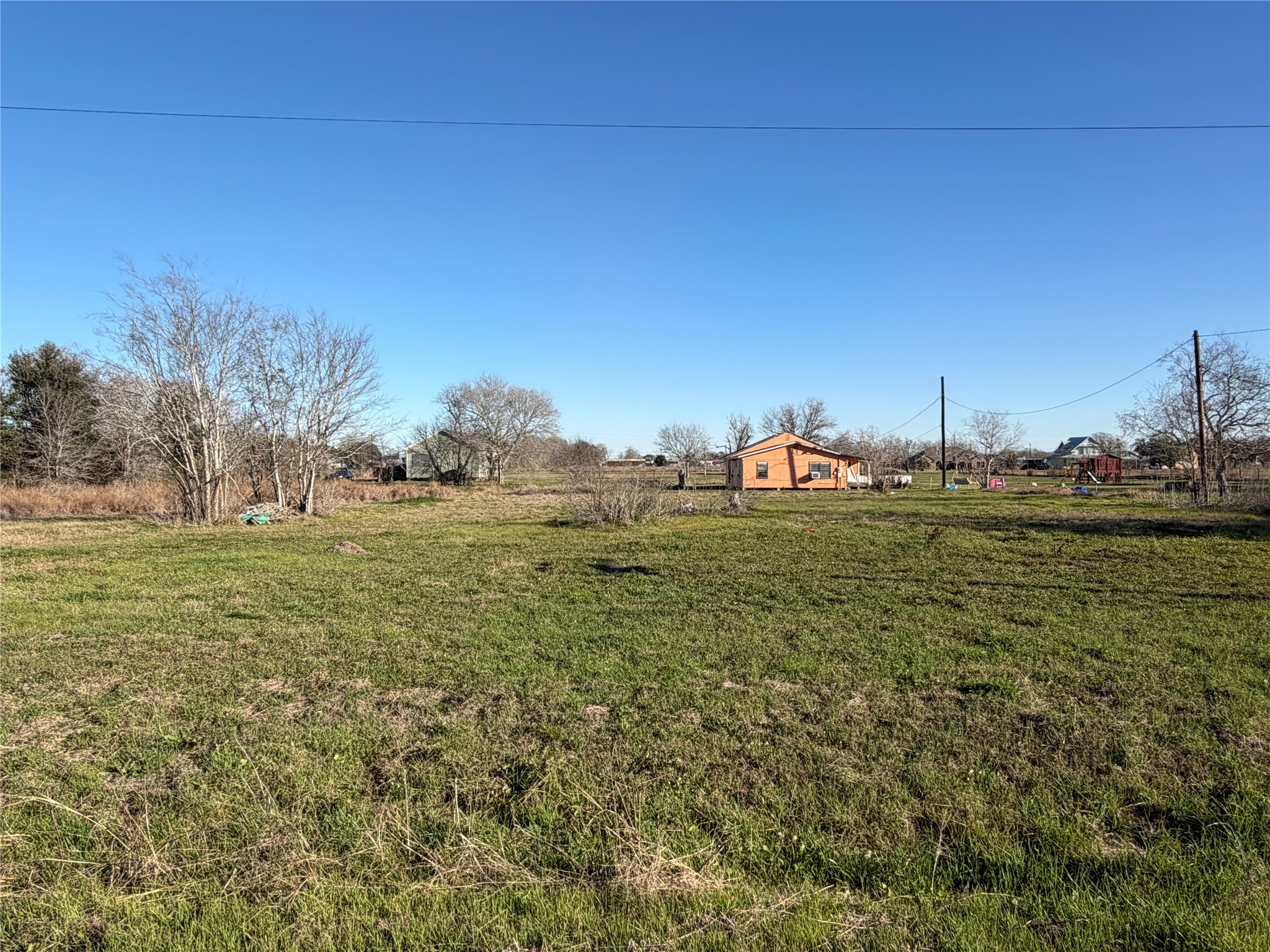 1508 Perryman Avenue Palacios, TX 77465 - Photo 4 of 5 a backyard of a house with trees in the background