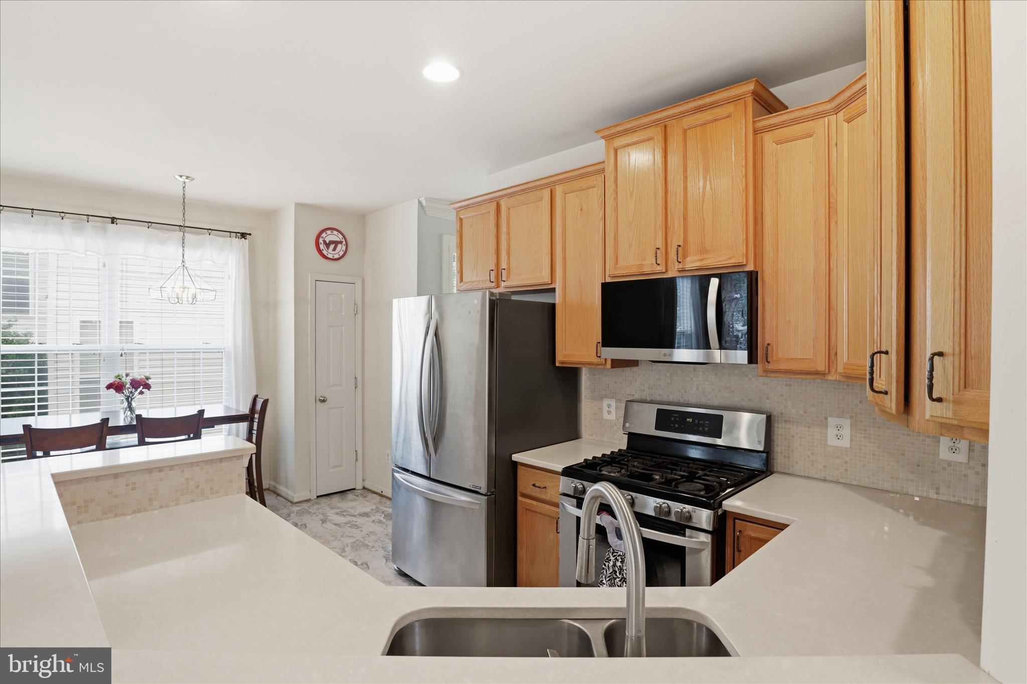 25352 Ripleys Field Drive Chantilly, VA 20152 - Photo 6 of 54 a kitchen with stainless steel appliances a refrigerator a stove a sink a microwave and living room view