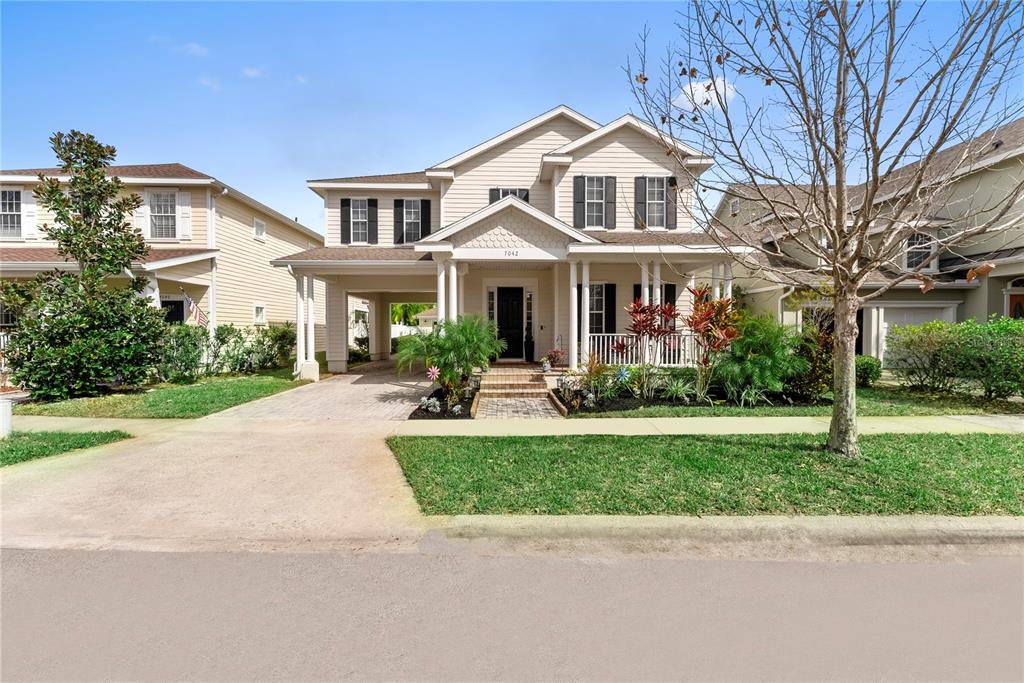 7042 Buttonbush Loop Harmony, FL 34773 - Photo 1 of 1 a front view of a house with garden and trees