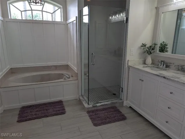 a bathroom with a granite countertop sink a toilet and shower