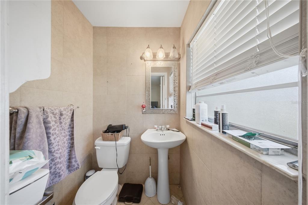 213 South 3rd Street Lake Mary, FL 32746 - Photo 11 of 30 a bathroom with a toilet sink and mirror