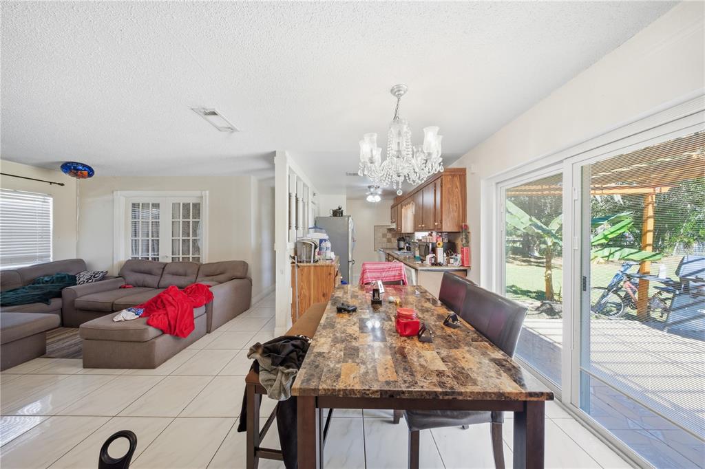 213 South 3rd Street Lake Mary, FL 32746 - Photo 7 of 30 a living room with furniture and a chandelier