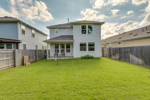 a view of swimming pool and deck in the backyard
