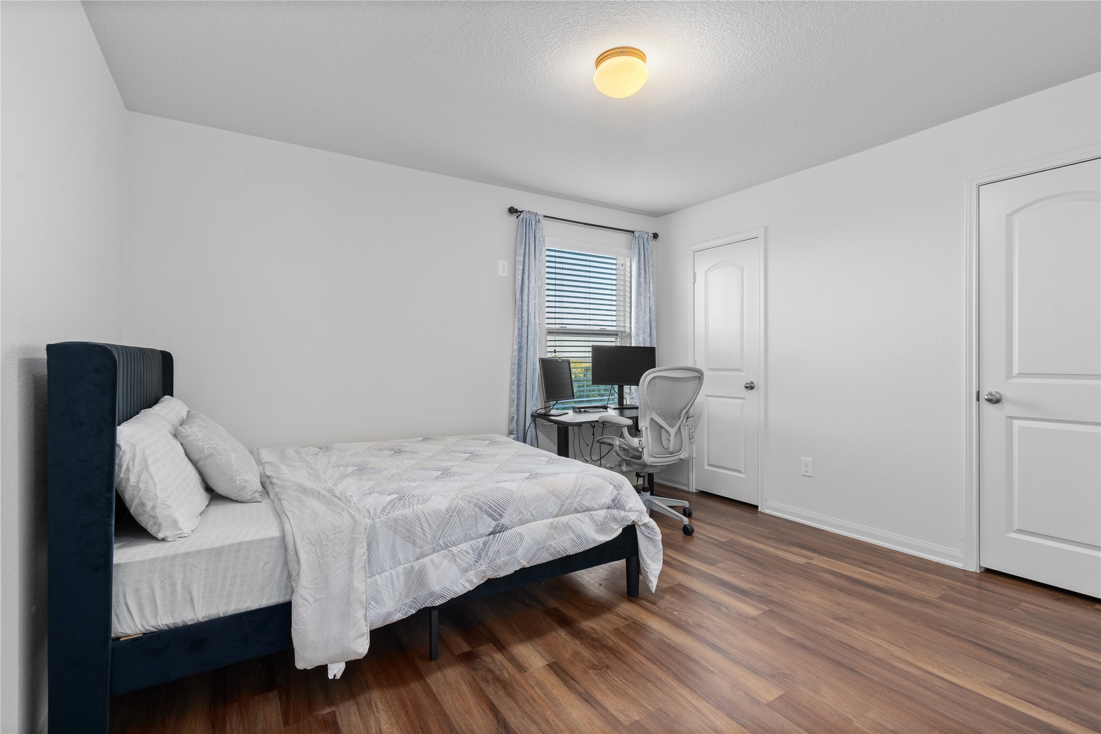 20205 Grover Cleveland Way Manor, TX 78653 - Photo 3 of 26 a bedroom with a bed and a table in it