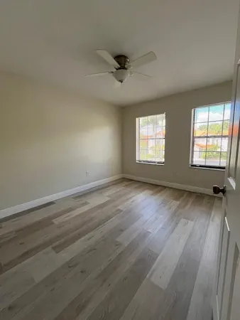 an empty room with wooden floor and closet