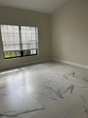 a view of an empty room and a window