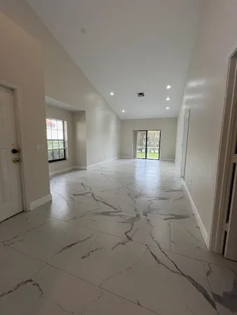 a view of a glass door with a yard from a window
