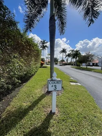 a sign board with a yard and lake view
