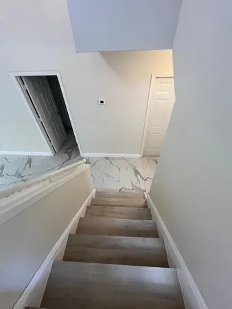 a view of staircase with white walls